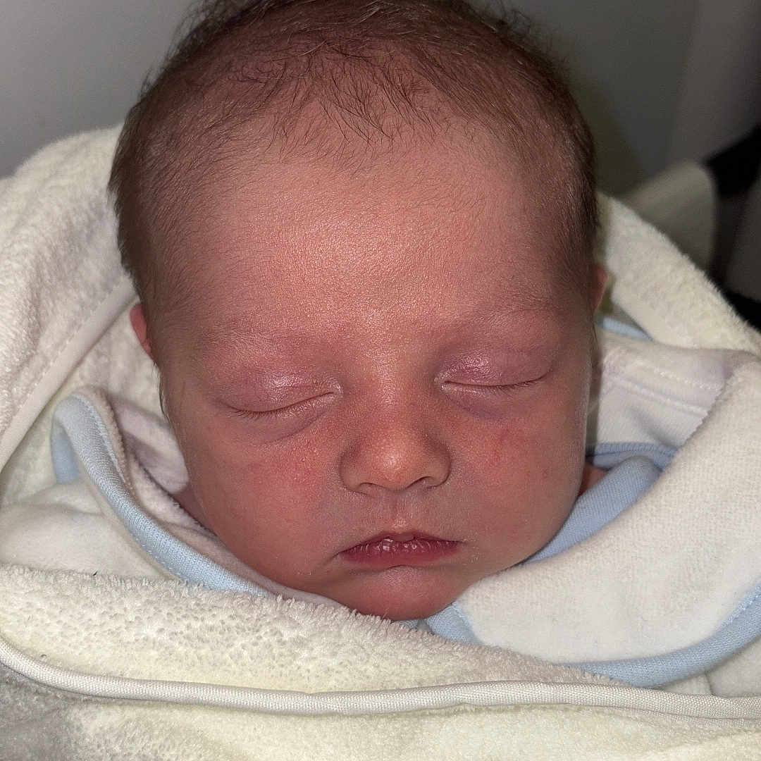 Kody is registered to the contest to win money with this photo: architecture, baby, bed, blanket, building, face, furniture, head, hospital, newborn, person, photography, portrait, quilt, sleeping, towel