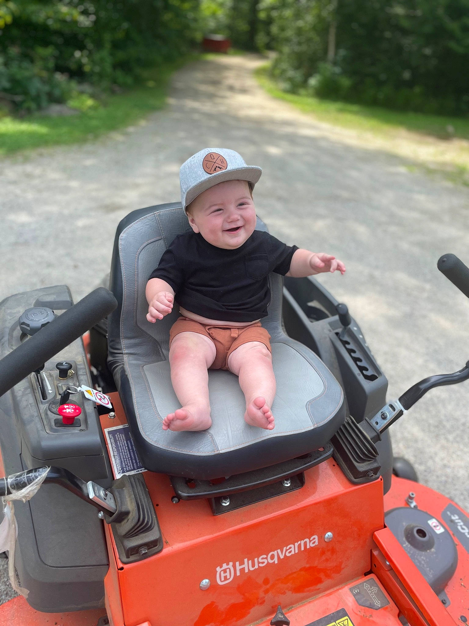 Colter is registered to the contest to win money with this photo: auto_part, automotive_design, automotive_exterior, baby, baby_carriage, baby_products, child, fun, grass, headwear, joy, lap, leisure, mode_of_transport, motor_vehicle, outdoor_recreation, person, plant, recreation, toddler