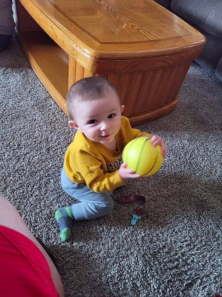 Craig is registered to the contest to win money with this photo: baby, carpet, child, comfort, floor, flooring, fun, furniture, grass, hardwood, leisure, person, play, sitting, smile, table, toddler, toy, varnish, wood