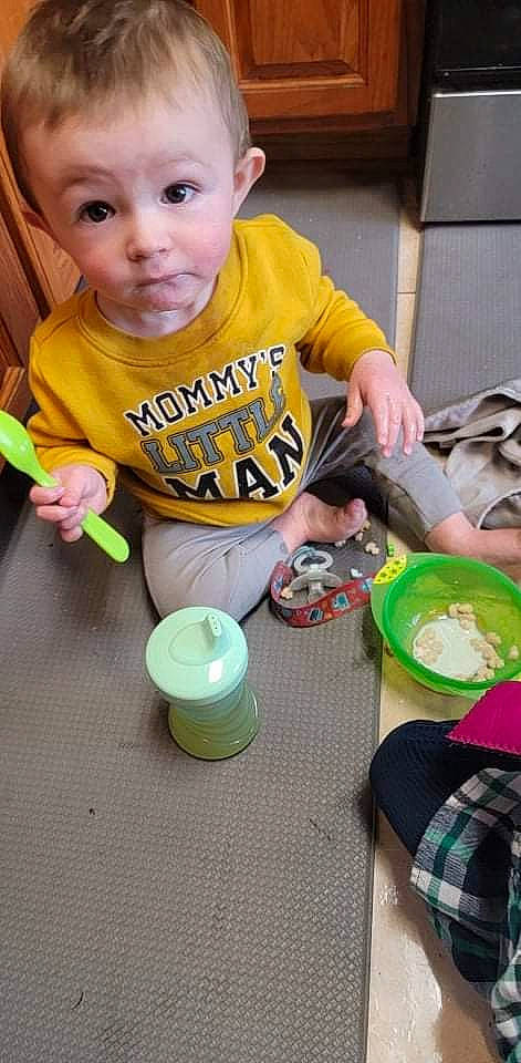 Craig is registered to the contest to win money with this photo: baby, baby_toddler_clothing, chair, child, comfort_food, cooking, desk, drink, drinkware, eating, food, fun, green, person, plate, sharing, surprise, t_shirt, table, tableware