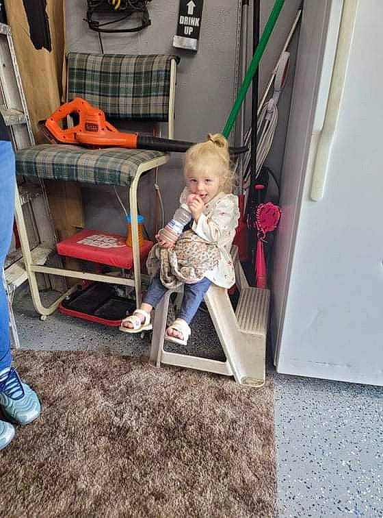 Rylee is registered to the contest to win money with this photo: baby, baby_carriage, baby_products, bag, boot, carpet, chair, child, floor, flooring, hardwood, jeans, leg, luggage_and_bags, person, room, shoe, sitting, sneakers, toddler