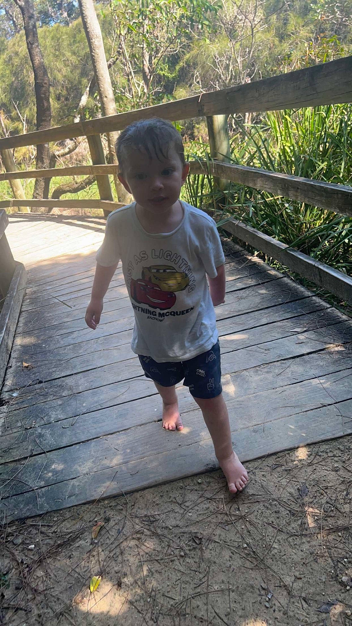 Kaylen is registered to the contest to win money with this photo: barefoot, child, foot, fun, grass, happy, human_leg, leaf, leisure, morning, people_in_nature, person, plant, shade, shorts, t_shirt, thigh, toddler, tree, water