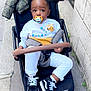 Liam Hugo participe au concours pour gagner de l'argent avec cette photo : child, toddler, stroller, pacifier, sweatshirt, disney, simba, jacket, shoes, sneakers, pants, sidewalk, urban, outdoor, curious, baby, person, clothing, street, daytime