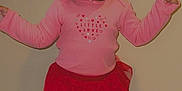 Milani joined the competition — help win amazing prizes! toddler, child, standing, pink_shirt, red_pants, heart_pattern, carpet, wall, curly_hair, pigtails, expression, indoors, person, clothing, footwear, cute, young_child, baby, portrait, casual