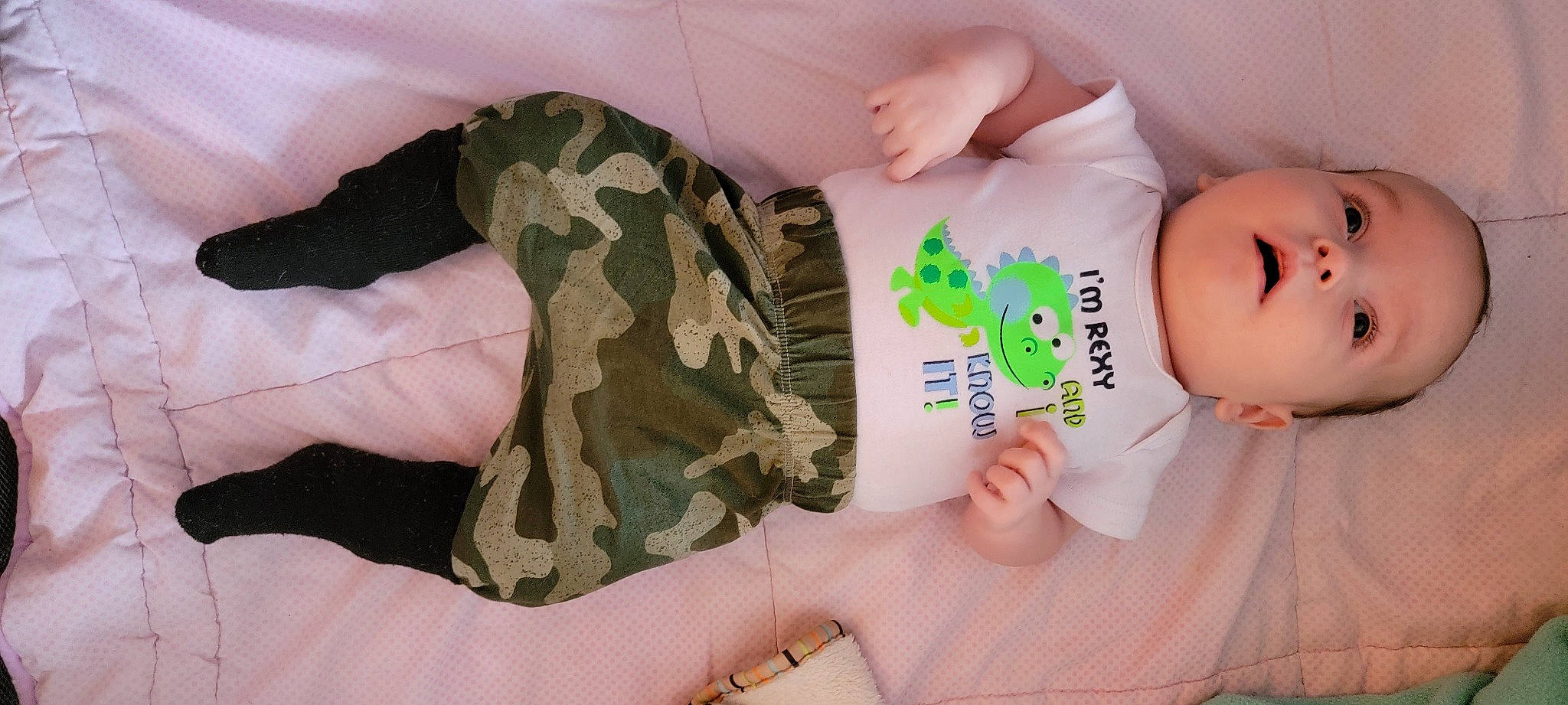 Ezra is registered to the contest to win money with this photo: arm, baby, baby_toddler_clothing, camouflage, comfort, finger, gesture, hand, military_camouflage, military_person, military_uniform, nail, pattern, person, skin, sleeve, textile, thumb, toddler, uniform