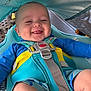 baby, smiling, car_seat, blue_clothing, baby_boy, child, happy, safety_harness, seatbelt, infant, tongue_out, outdoor, sunshade, closeup, cute, person, seat, child_safety, baby_shorts, baby_face