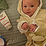 Lukas is registered to the contest to win money with this photo: baby, infant, bathrobe, bedspread, cream, skincare, eczema_cream, face, eyes, hands, foot, blanket, fabric, soft_texture, lying_down, indoors, cute, skin_care, child, cozy