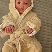 Lukas joined the competition — help win amazing prizes! baby, child, robe, hood, blanket, bed, feet, hands, cute, infant, skin, soft, warm, lying_down, portrait, indoors, cozy, expression, comfort, sleepwear