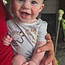 baby, child, smiling, blue_eyes, onesie, striped_clothing, hand, adult_hand, indoor, person, cute, happy, infant, skin, face, portrait, sitting, human, young, holding