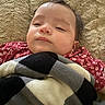 baby, blanket, candid, child, closeup, comfort, cozy, face, hair, head, indoors, infant, lying_down, pattern, plaid, red_clothing, resting, sleepy, soft, texture