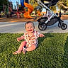baby, grass, playground, stroller, smile, sunlight, park, child, outdoor, happy, toy, infant, daylight, nature, greenery, casual_clothing, sitting, cheerful, recreation, family