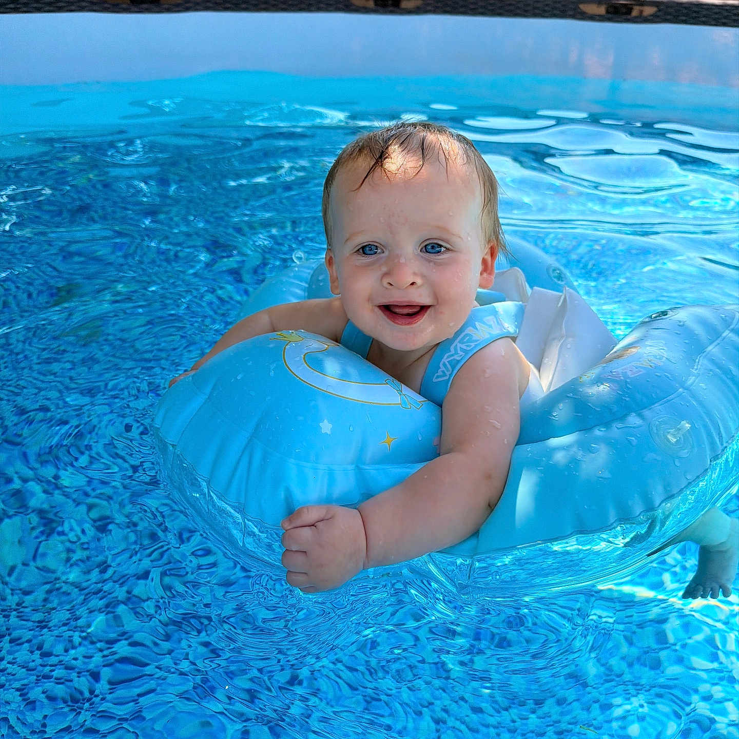 Hazel joined the competition — help win amazing prizes! baby, pool, water, inflatable_ring, smiling, child, outdoor, summer, blue, floating, happy, swimming, sunlight, backyard, safety, infant, playful, fun, cute, wet