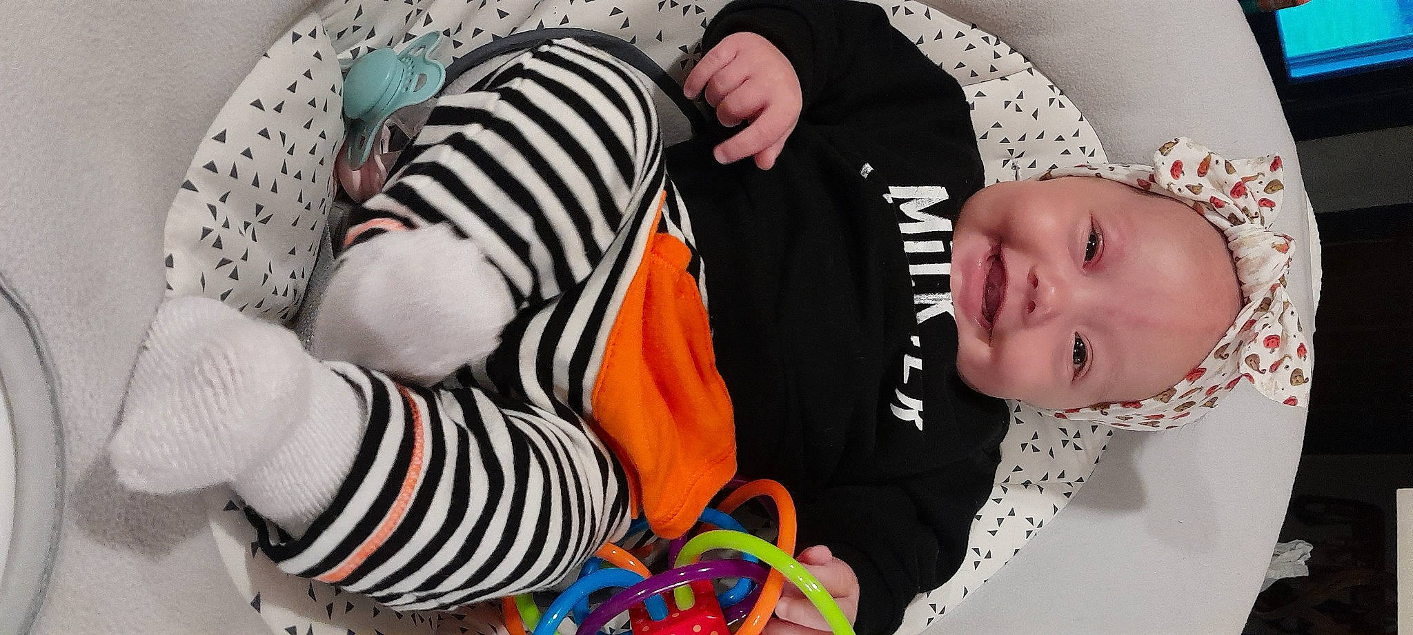 Kodie joined the competition — help win amazing prizes! baby, baby_toddler_clothing, black, child, comfort, event, fun, happy, headgear, joy, linens, orange, pattern, person, photograph, product, sleeve, smile, snapshot, textile