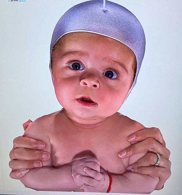 Ezekiel is registered to the contest to win money with this photo: baby, cheek, eye, eyebrow, eyelash, finger, forehead, gesture, hand, happy, headwear, iris, jaw, lip, mouth, neck, nose, person, pink, skin