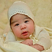 Darla joined the competition — help win amazing prizes! baby, infant, knit_hat, bonnet, blanket, soft_texture, close_up, portrait, cheeks, eyes, mouth, hands, cozy, indoor, cream_color, laying_down, cute, newborn, clothing, studio_style