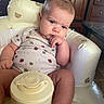 Rosetta joined the competition — help win amazing prizes! baby, infant, child, onesie, baby_bottle, cushioned_chair, teddy_bear_pattern, serious_expression, indoor, kitchen, wooden_cabinet, table, floor, person, face, sitting, cute, plush, furniture, home