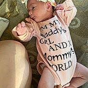 Rosetta joined the competition — help win amazing prizes! baby, newborn, infant, onesie, headband, bow, lying_down, couch, blanket, hand, fingers, legs, skin, clothing, portrait, indoor, cozy, family, nursery, text_on_clothing