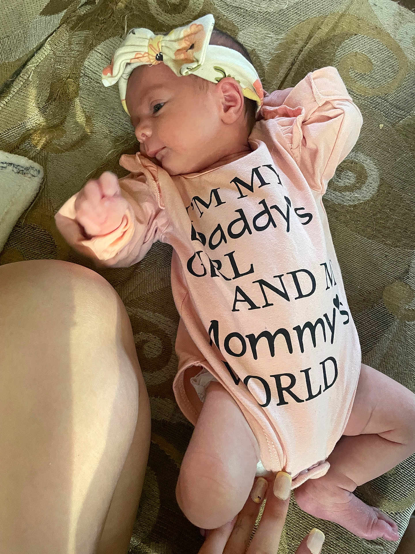 Rosetta joined the competition — help win amazing prizes! baby, newborn, infant, onesie, headband, bow, lying_down, couch, blanket, hand, fingers, legs, skin, clothing, portrait, indoor, cozy, family, nursery, text_on_clothing