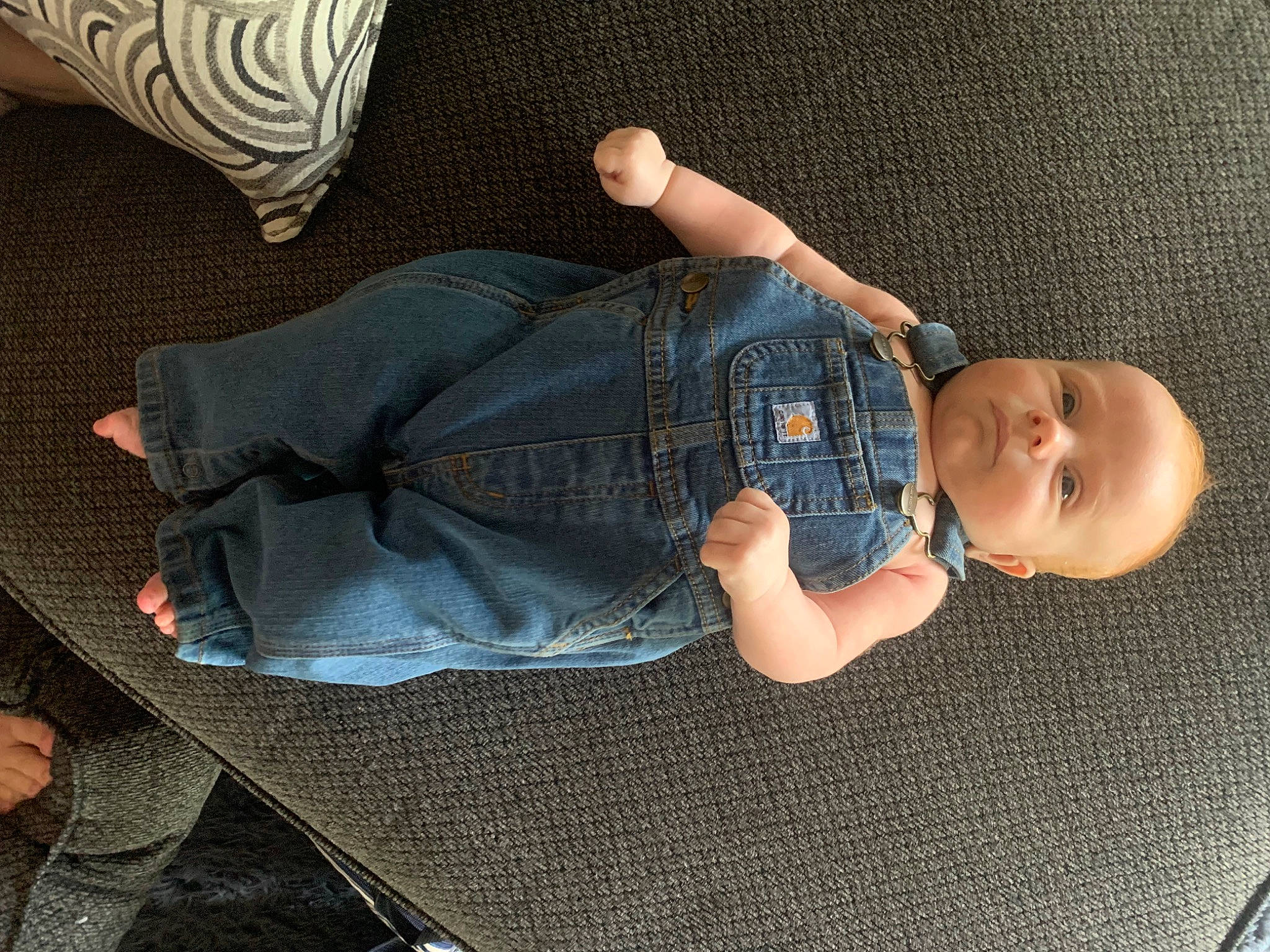 Axel is registered to the contest to win money with this photo: baby, baby_toddler_clothing, comfort, cool, denim, finger, hand, headgear, human_leg, joint, leg, linens, pattern, person, sitting, sleeve, t_shirt, thigh, toddler, wood