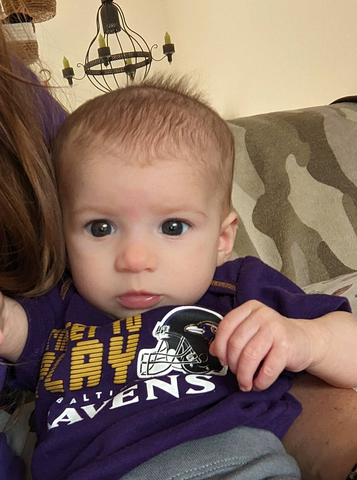 Izzy is registered to the contest to win money with this photo: baby, baby_products, baby_toddler_clothing, brown_hair, cheek, child, comfort, cool, eye, eyelash, fashion_accessory, happy, iris, nail, person, play, sitting, skin, sleeve, t_shirt