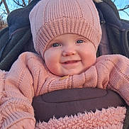 Taytum joined the competition — help win amazing prizes! baby, child, smile, hat, knitwear, sweater, outdoor, winter_clothing, blue_eyes, cheeks, person, portrait, happy, cozy, bundle, nature, trees, daylight, face, cute