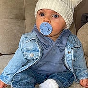 Daniel participe au concours pour gagner de l'argent avec cette photo : baby, beanie, bonnet, cap, clothing, coat, couch, face, footwear, furniture, hat, head, jacket, jeans, pants, person, photography, portrait, shoe, sitting