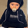 Daniel participe au concours pour gagner de l'argent avec cette photo : baby, beanie, biting, cap, clothing, eating, face, food, footwear, hat, head, person, shoe, sitting