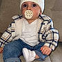 Daniel a rejoint le concours — aidez-le/la à gagner de superbes lots ! baby, beanie, cap, clothing, coat, couch, cushion, face, footwear, furniture, hat, head, jacket, jeans, pants, person, photography, portrait, shoe, sitting