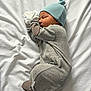Bohdie is registered to the contest to win money with this photo: baby, blanket, child, clothing, cozy, cute, hat, indoors, infant, lying_down, mittens, newborn, pajamas, peaceful, portrait, resting, sleeping, small, soft, white