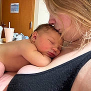 Bohdie is registered to the contest to win money with this photo: affection, baby, bedroom, closeup, clothing, cup, door, face, fan, hair, indoor, kiss, love, mother, newborn, person, rest, skin, sleeping, woman