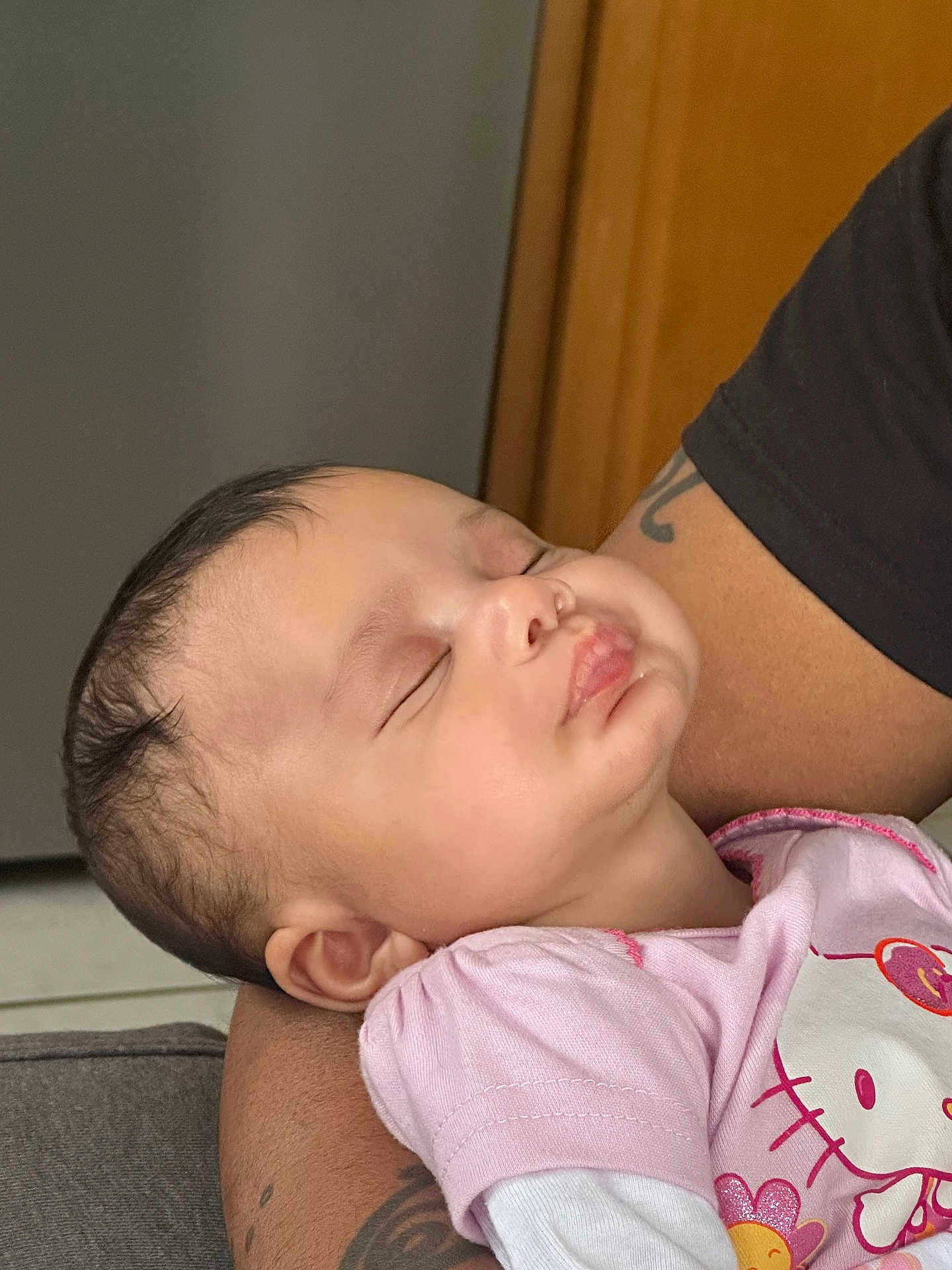Amayah joined the competition — help win amazing prizes! baby, sleeping, child, arm, tattoo, pink_shirt, hello_kitty, person, infant, face, closed_eyes, cute, indoor, rest, comfort, soft_lighting, young_child, toddler, peaceful, portrait