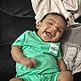 Roman joined the competition — help win amazing prizes! baby, infant, smiling, laughing, onesie, green_clothing, couch, blanket, towel, living_room, happy, cute, chubby_cheeks, hand_motion, portrait, sitting, soft_fabric, skin, hair, playful