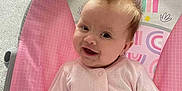 Maddison joined the competition — help win amazing prizes! baby, infant, child, smiling, pink_clothing, baby_seat, monkey_graphic, sun_graphic, rainbow_graphic, hair_spiky, drool, happy, cute, indoors, seat_belt, patterned_fabric, colorful, portrait, sitting, young_child