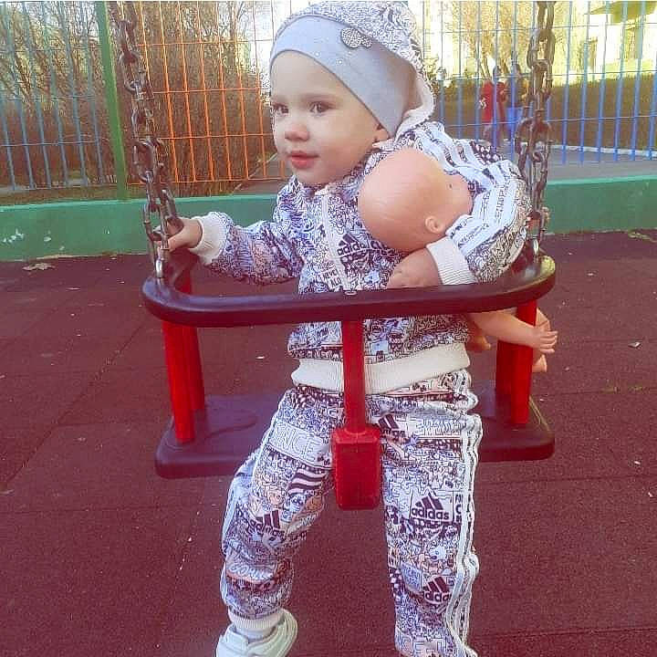 Antonia is registered to the contest to win money with this photo: baby, baby_toddler_clothing, beauty, fun, grass, happy, headwear, human_body, human_leg, knee, leg, leisure, outdoor_play_equipment, person, pink, recreation, shoe, sleeve, smile, sneakers