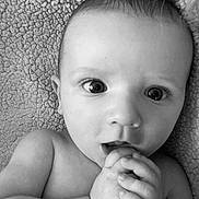John is registered to the contest to win money with this photo: baby, infant, black_and_white, close_up, face, foot, hand, texture, blanket, curious, wide_eyes, expression, skin, portrait, child, cute, indoors, young, person, lying_down