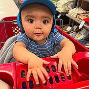 Matteo joined the competition — help win amazing prizes! baby, child, shopping_cart, blue_cap, striped_shirt, store_aisle, textiles, shelves, curious, hands, indoor, retail, shopping, infant, person, cute, wide_eyes, red, clothing, baby_in_cart