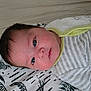 Amelia participe au concours pour gagner de l'argent avec cette photo : baby, infant, face, blue_eyes, striped_clothing, onesie, blanket, pattern, lying_down, curious, closeup, head, cheeks, young_child, indoor, soft_light, skin, hair, expression, resting
