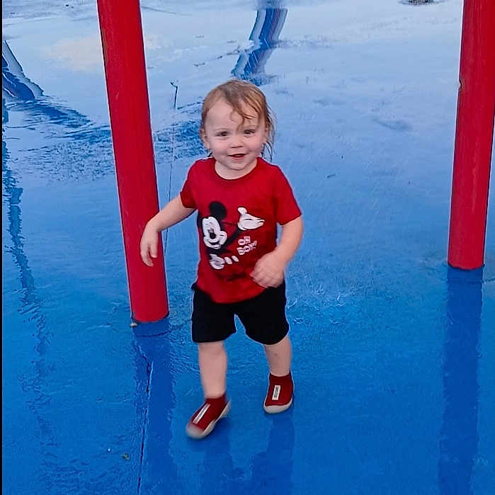 Adrian is registered to the contest to win money with this photo: amusementpark, boy, child, clothing, face, footwear, head, male, outdoorplayarea, outdoors, pants, person, photography, playarea, portrait, shoe, shorts, t_shirt, water, waterpark