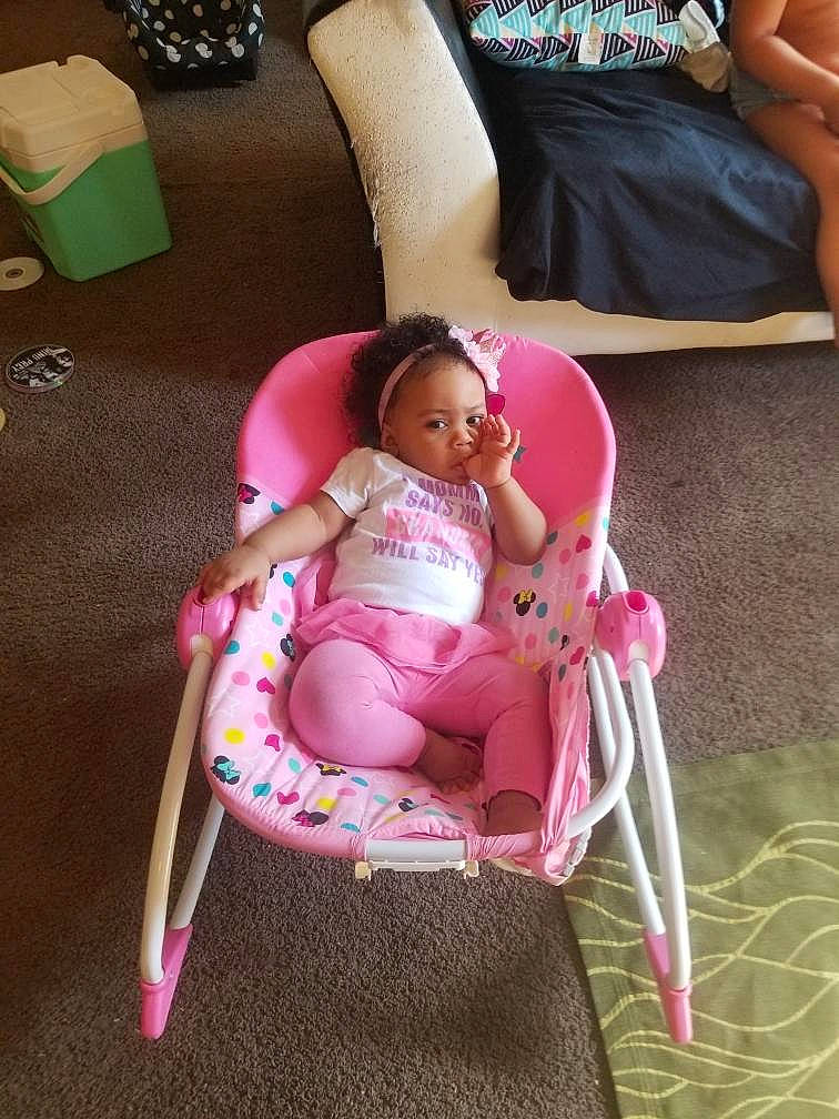 Lailani joined the competition — help win amazing prizes! baby, baby_carriage, baby_products, baby_toddler_clothing, chair, child, comfort, face, foot, head, human_body, human_leg, knee, lap, leg, magenta, person, pink, product, thigh
