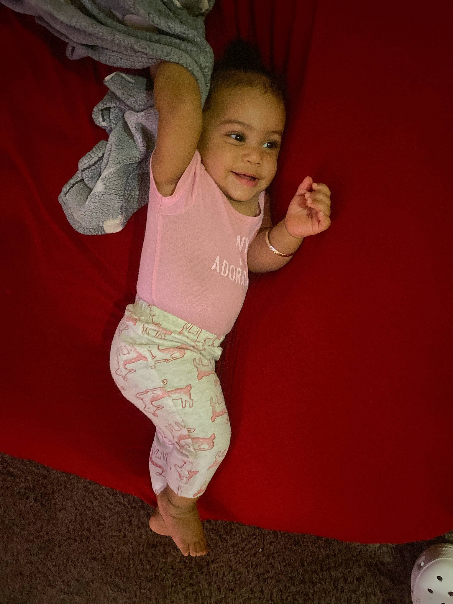 Lailani is registered to the contest to win money with this photo: arm, baby_toddler_clothing, chest, eye, face, finger, flash_photography, gesture, happy, human_body, joint, joy, knee, leg, person, pink, sleeve, smile, standing, stomach