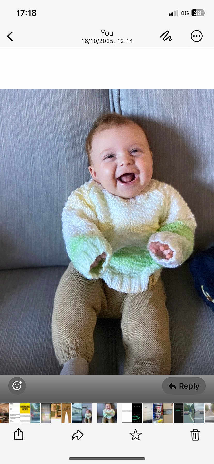 Joey joined the competition — help win amazing prizes! baby, child, smiling, sweater, knitwear, pants, sitting, couch, indoor, happy, face, person, infant, young_child, cozy, cute, portrait, clothing, home, seated