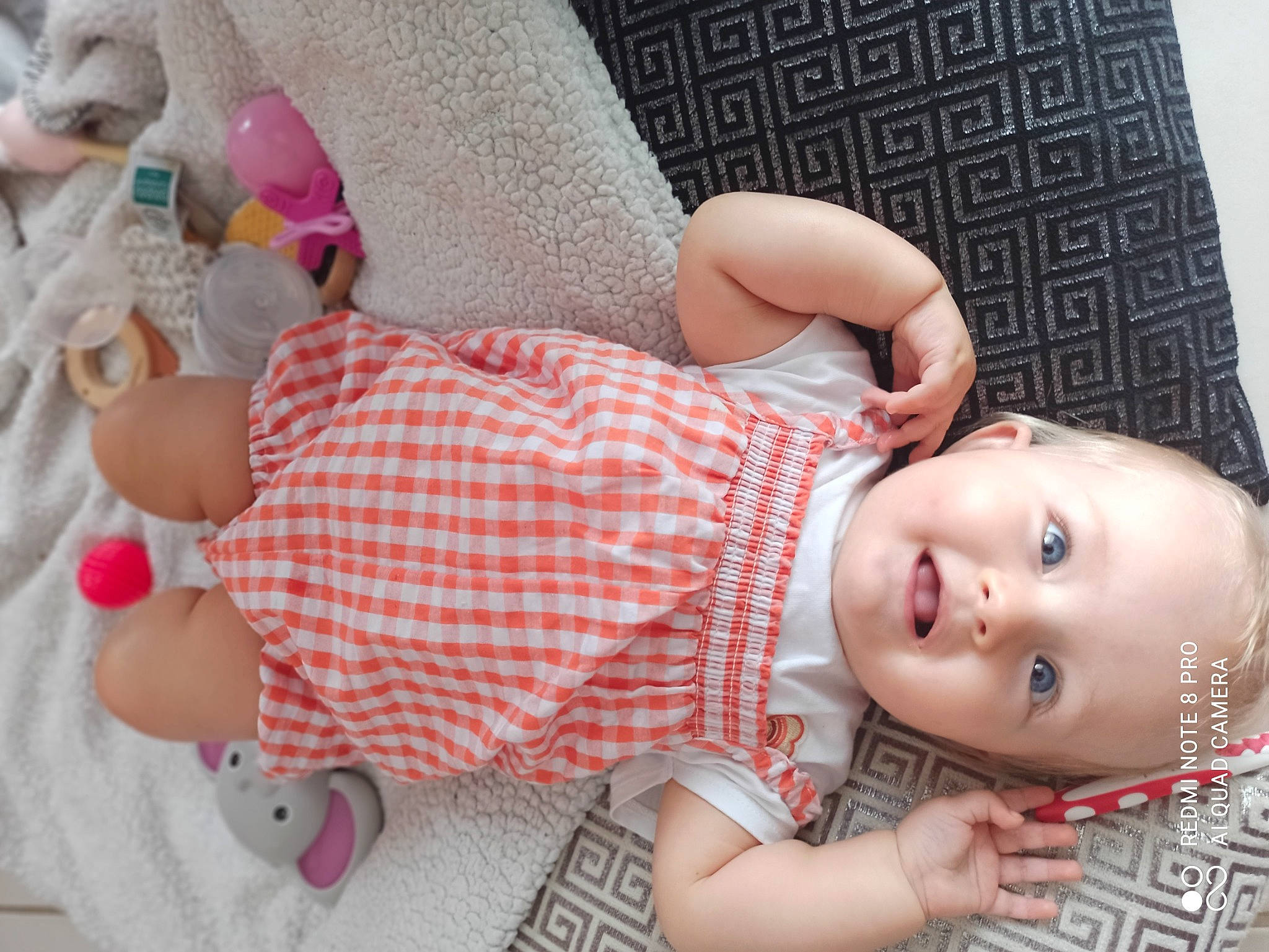 Luna participe au concours pour gagner de l'argent avec cette photo : arm, baby, baby_products, baby_toddler_clothing, child, comfort, doll, flash_photography, hand, human_body, linens, pattern, person, pink, plaid, product, skin, smile, textile, toddler