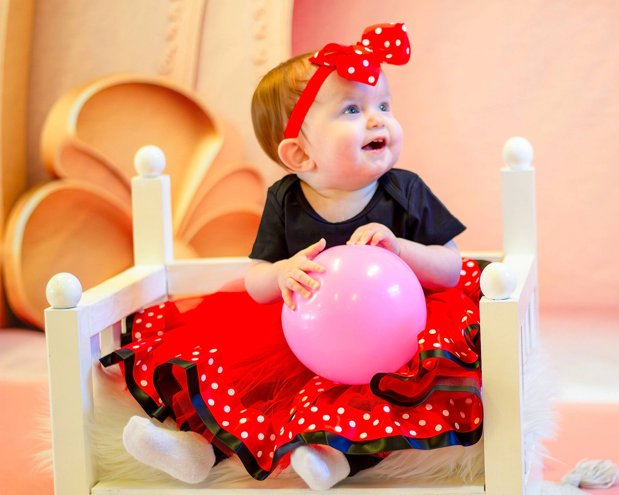 Kassidy joined the competition — help win amazing prizes! baby, baby_playing_with_toys, baby_toddler_clothing, balloon, child, event, fun, happy, hat, headwear, magenta, party, party_supply, person, pink, recreation, red, sitting, sleeve, smile