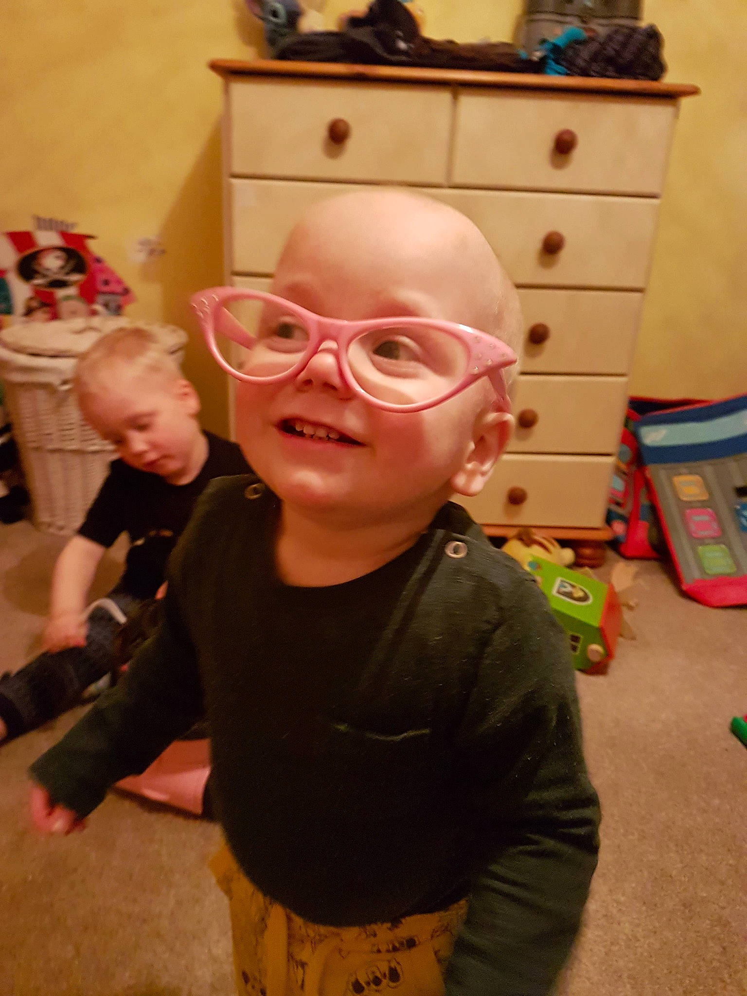 Rupert is registered to the contest to win money with this photo: cheek, child, cool, ear, eyewear, fun, glasses, head, headwear, joy, person, personal_protective_equipment, room, smile, toddler, vision_care
