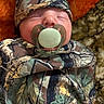 Daylan is registered to the contest to win money with this photo: baby, pacifier, sleeping, camouflage, blanket, hat, infant, child, face, closeup, resting, cute, soft, warm, indoors, person, newborn, cozy, portrait, peaceful