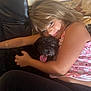 Candi Cortina is registered to the contest to win money with this photo: black_dog, child, clothing, couch, cozy, cute, dog, face, friendly, hair, happy, hug, indoor, patterned, pet, pink, skin, sleeveless, smile, tongue