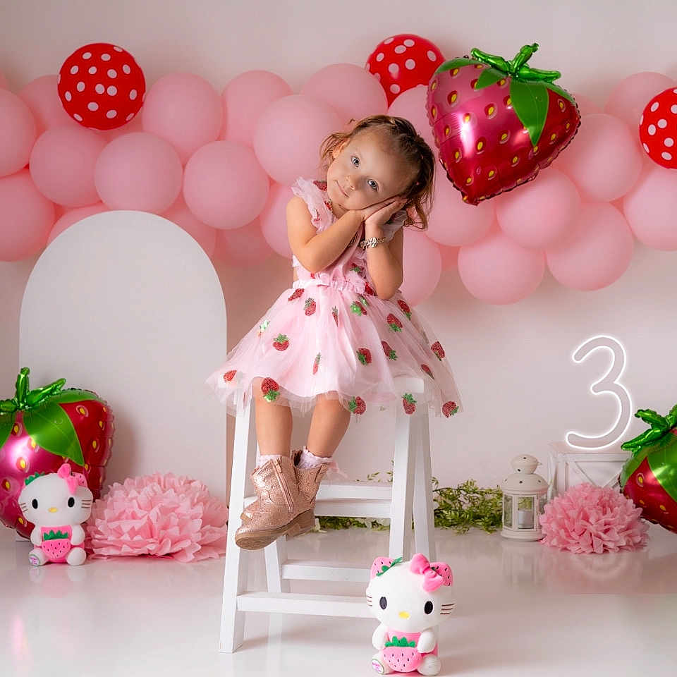Abdala is registered to the contest to win money with this photo: balloon, birthdaycake, cake, child, clothing, cream, dessert, face, female, footwear, fun, furniture, girl, head, party, people, person, shoe, sitting, toy