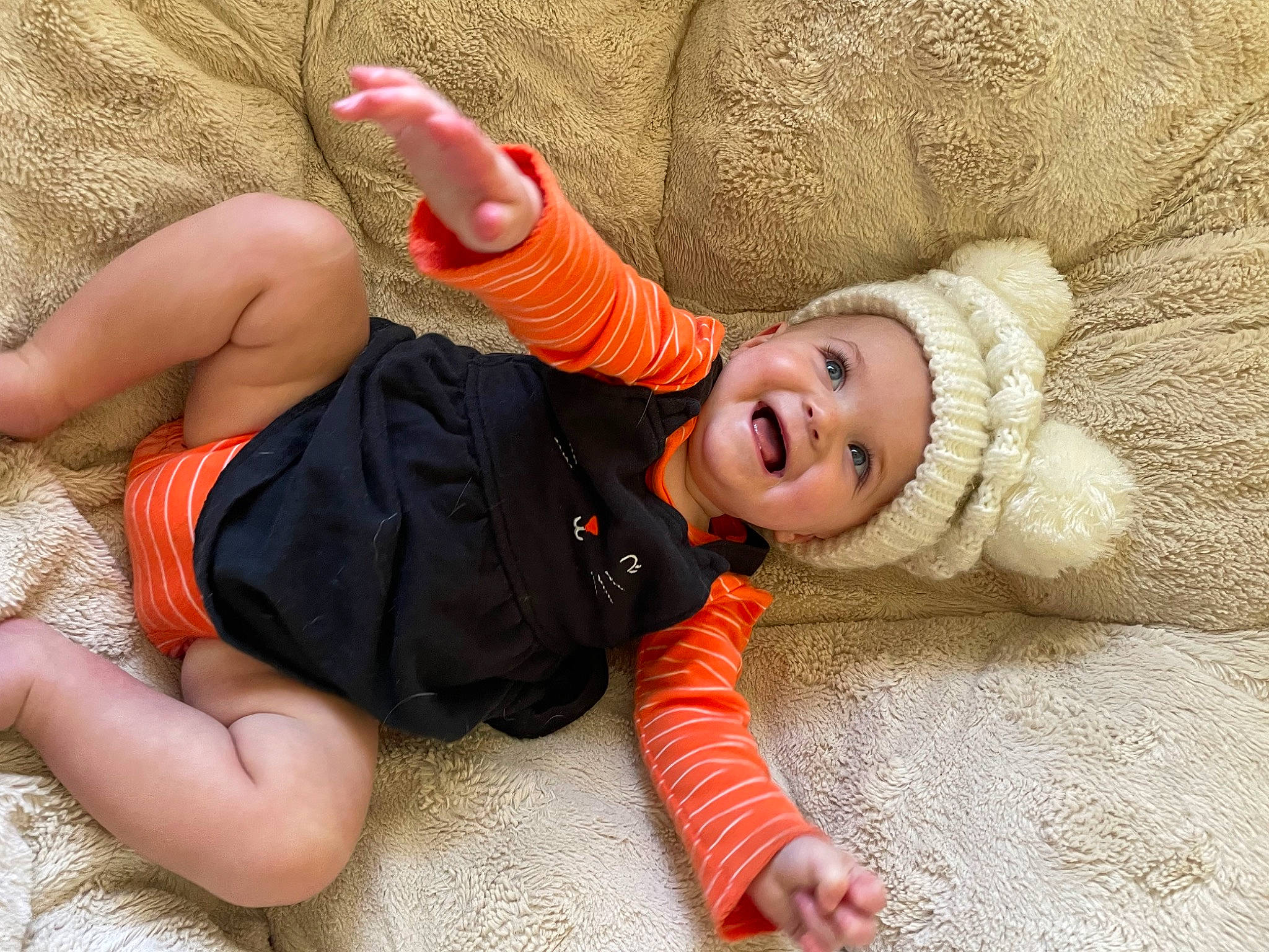 Araceli joined the competition — help win amazing prizes! baby, baby_toddler_clothing, comfort, face, facial_expression, finger, fun, gesture, happy, headgear, headwear, human_body, leg, mouth, orange, person, plant, skin, smile, toddler
