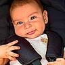 baby, infant, child, face, smile, eyes, hand, car_seat, harness, clothing, cute, portrait, seat_belt, safety, cute_expression, close_up, child_seat, young_child, baby_fashion, adorable