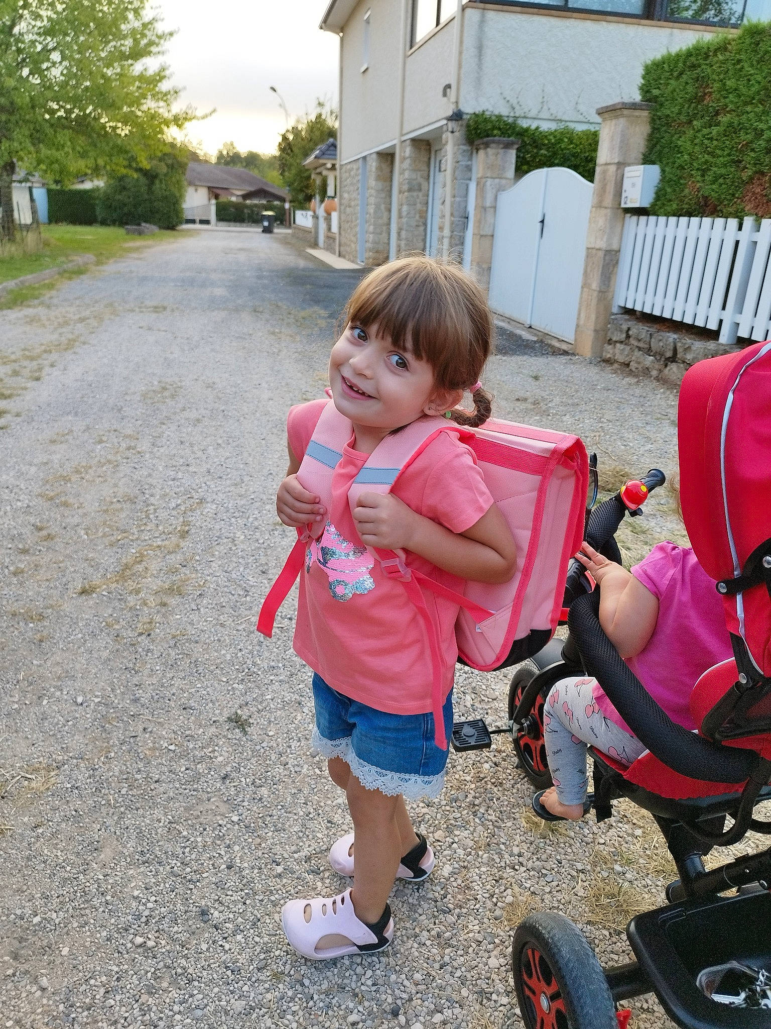 Myah participe au concours pour gagner de l'argent avec cette photo : asphalt, baby, baby_carriage, baby_products, child, fun, grass, joy, leg, leisure, person, pink, plant, recreation, road_surface, shorts, sky, tire, toddler, travel